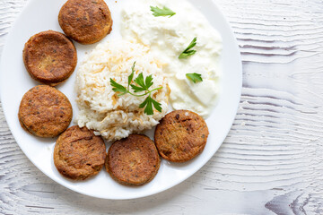 Close-Up of Kotlety Mielone Meatballs with Greens on a White Plate

