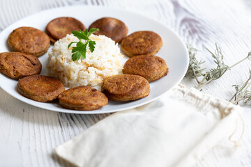 Close-Up of Kotlety Mielone Meatballs with Greens on a White Plate
