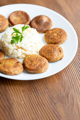 Close-Up of Kotlety Mielone Meatballs with Greens on a White Plate
