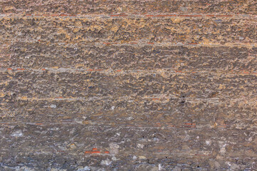 Textured stone wall with layers of rough, natural surface patterns