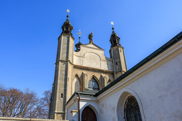 Historic gothic church architecture with twin towers against clear blue sky