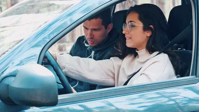Young man and woman riding together in car in forest. Male instructor helps girl to start driving car in right way. Woman riding wrong and man scream and yell on her. Girl starts crying.