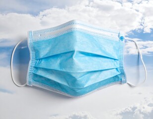 Blue Disposable Face Mask Against Cloudy Sky.