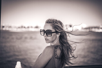 Elegant woman enjoying boat trip in Algarve, Portugal travel lifestyle