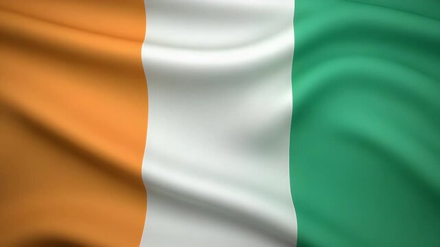 Dynamic Ivory Coast flag waving proudly in the breeze creates a vibrant patriotic display of national pride and celebration