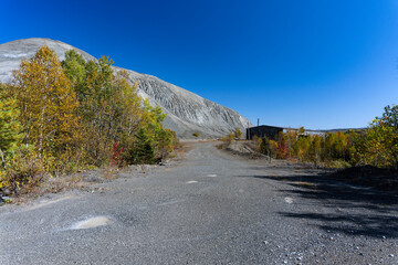 A mountain of mining wastes near a building