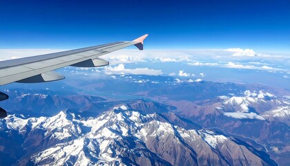 Aerial View of Snowy Mountains from Airplane Window.