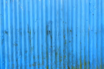 Blue corrugated metal texture background. Rusted and weathered texture is ideal for abstract, industrial, or grunge themes