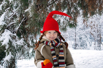 a little girl in an elf costume in the fores