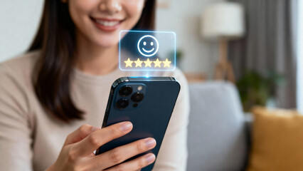 A woman smiles while holding a smartphone displaying a glowing 5-star review with a floating holographic smiley face, in a cozy living room with a couch and lamp