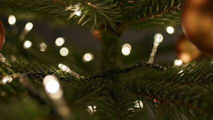 A dreamy close-up of a Christmas tree branch with soft, twinkling white fairy lights creating a beautiful bokeh effect perfect for a peaceful and magical holiday background - Powered by Adobe
