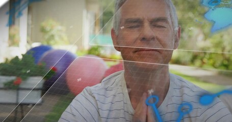 Senior man closing eyes holding prayer pose in backyard, animating network overlay for wellness - Powered by Adobe