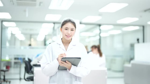 A Clinical Research Coordinator uses a tablet for electronic data capture, managing patient eCRFs and ensuring data integrity for a clinical trial in a modern research facility.
