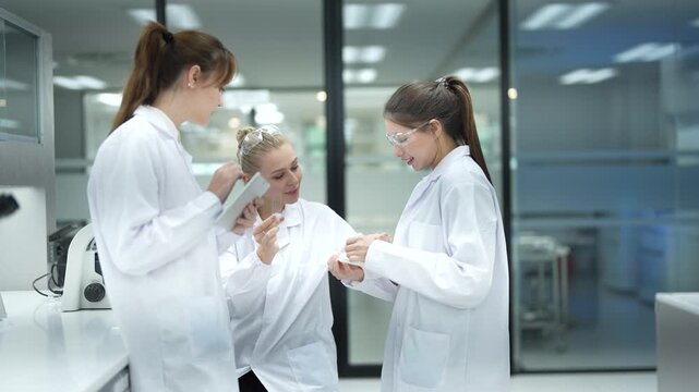 A clinical research team performs data validation, comparing a subject's results on a tablet with the official study protocol to ensure data integrity for a new drug trial.