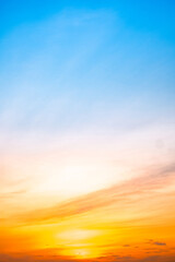 Fototapeta premium Beautiful , luxury soft gradient orange gold clouds and sunlight on the blue sky perfect for the background, take in evening,Twilight, Large size, high definition landscape photo,Vertical