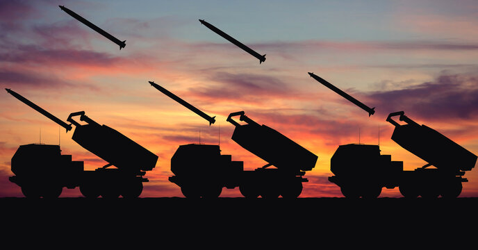 Silhouette of an M142 HIMARS artillery rocket system against the backdrop of sunset. Massive rocket attack. Illustration for a design on the theme of military defense and military technology.