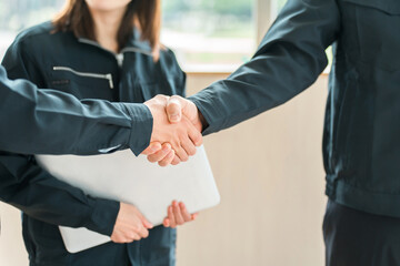 Male and female businessmen in work clothes shaking hands, workers
