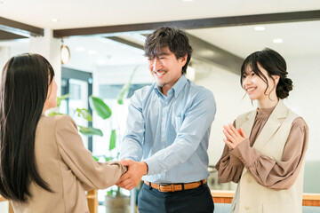Businessmen shaking hands to greet, introduce themselves and conclude a contract in a corporate office
