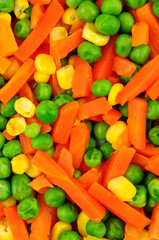 Cooked mixed vegetable background detail including carrots, peas and sweetcorn