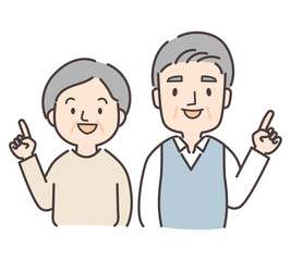笑顔で指差しをするシニア夫婦