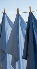 Blue Shirts Drying on a Clothesline in the Sun.