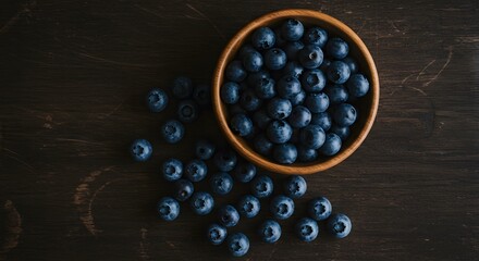 Fresh Blueberries in Wooden Bowl on Dark Wooden Surface for Healthy Food and Nutrition Marketing