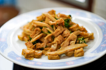 Homemade vegetarian dish with tofu, bamboo shoots, and greens