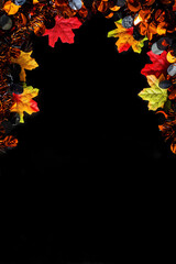 Halloween party decorations with maple leaves on black background for Halloween holiday concept.