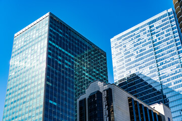 Fototapeta premium Business city. City architecture. Modern glass building. Reflective glass architecture. Architecture business district. Building architecture. Business building. Glass building. Urban business core