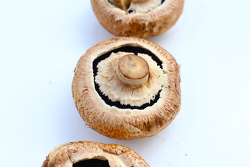 Fresh portobello mushrooms with visible gills underneath.