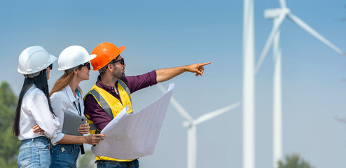engineer team inspection check control wind power machine construction installation in wind energy factory. technician professional worker discussion check for maintenance electronic wind turbine