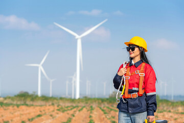 Woman engineer inspection check control wind power machine construction installation in wind energy factory. girl technician professional worker check wind power machine for maintenance turbine