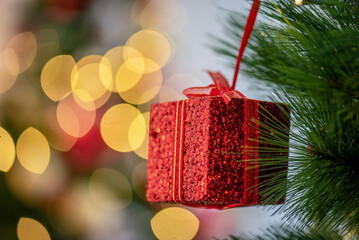 Christmas Tree with Decorations and Gift box present on colorful pine tree with laugh smile happy parent family celebrate party in Christmas day at home. colorful balls on pine tree with bokeh.