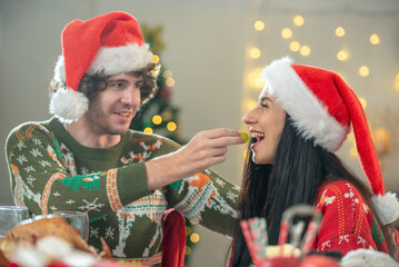 couple lover celebration kiss feed food together in Christmas thanksgiving day. enjoy happy party to have dinner together with full food of turkey drink and present for celebrate merry Christmas