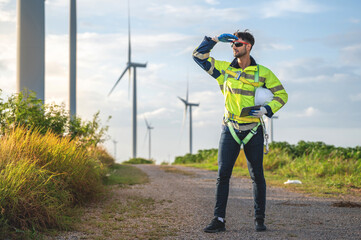 man visionary engineer looking ahead wind inspector looking forward inspection check control wind power machine out door wind energy factory.technician professional worker check wind power turbine