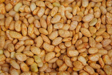 Dried yellow beans spread on a wooden surface