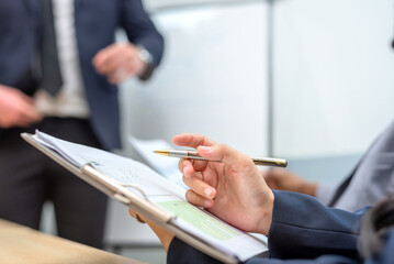 A business meeting with a man and woman in suits