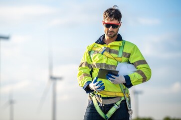 Male man engineer inspection by tablet gesture check control wind power machine out door wind energy factory. technician professional worker check wind power machine turbine field inspection
