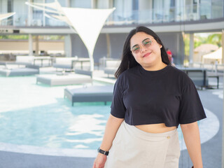 Body positive curvy Asian woman smiling and enjoying casual day.