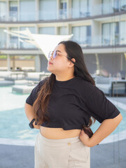 Body positive curvy Asian woman smiling and enjoying casual day.