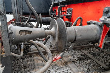 Close-Up of Train Wagon Connection, Hydraulic Pipes, and Mechanical Parts