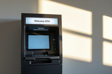 Welcome ATM cash machine with blank screen in sunlight, automated teller providing banking access and secure cash withdrawal