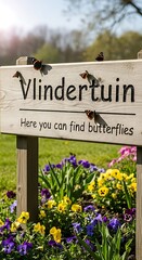 Vlindertuin Sign with Butterflies and Colorful Flowers in Garden.