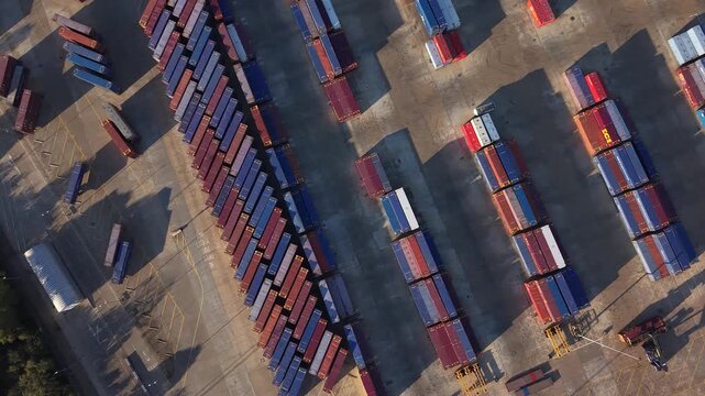 Aerial circling view looking down above rows of shipping containers at Tilbury 2 storage facility