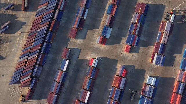 Aerial Birdseye view over stacked shipping containers in Tilbury 2 port storage facility, Essex