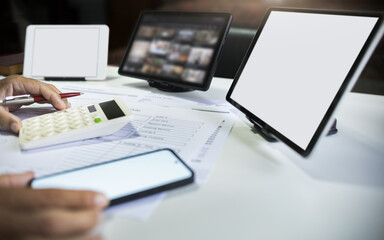 close up shot, hand of businessman calculate cost, profit from e-commerce business working online at home with tablet and mobile phone