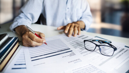 serious businessman working on desk checking for account statement  he worried about businesses experiencing financial difficulties