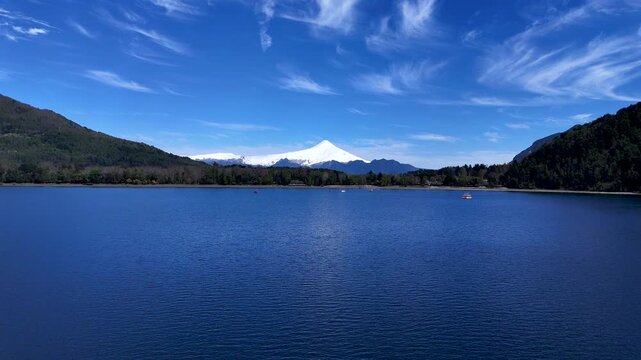 4K Drone Footage Flying Forward Over a Calm Lake Toward Villarrica Volcano