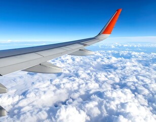 Obraz premium Aerial view from airplane window, wing over fluffy clouds