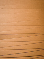 Macro view of zigzag-stacked corrugated cardboard showing cut edges and layered texture. Ideal for abstract backgrounds, packaging design, or material studies.